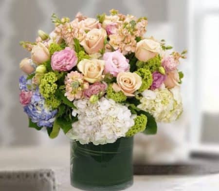 Premium blossoms including roses, hydrangea and other seasonal blossoms in subtle colors.